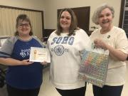 Megan Smith receiving her member certificate, gift bag